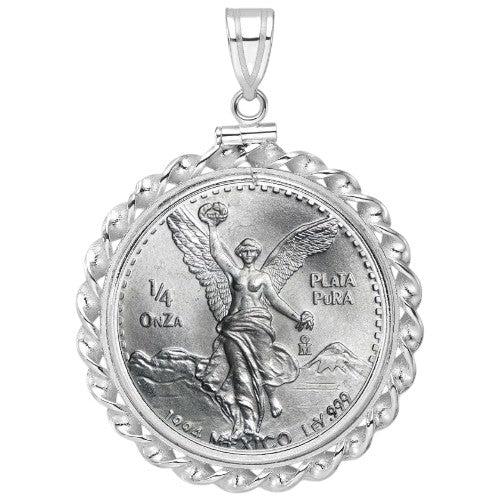 Mexican 1/4 Onza Silver Libertad coin pendant from 1984, .999 fine plata pura, featuring Winged Victory with volcanoes, set in a scalloped white gold bezel.
